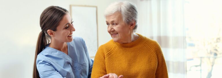 Caregiver talking with a senior woman at home
